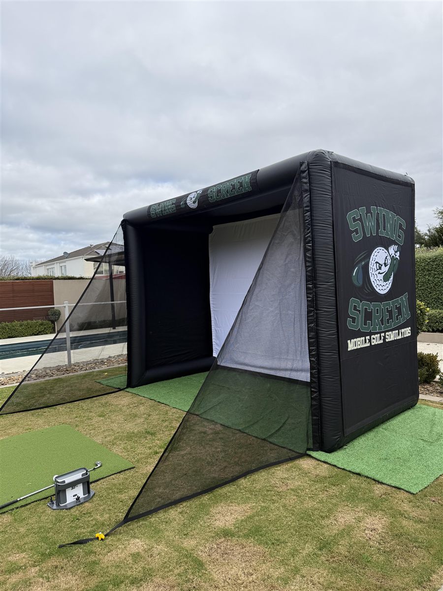Swing Screen inflatable golf simulator set up on a backyard lawn
